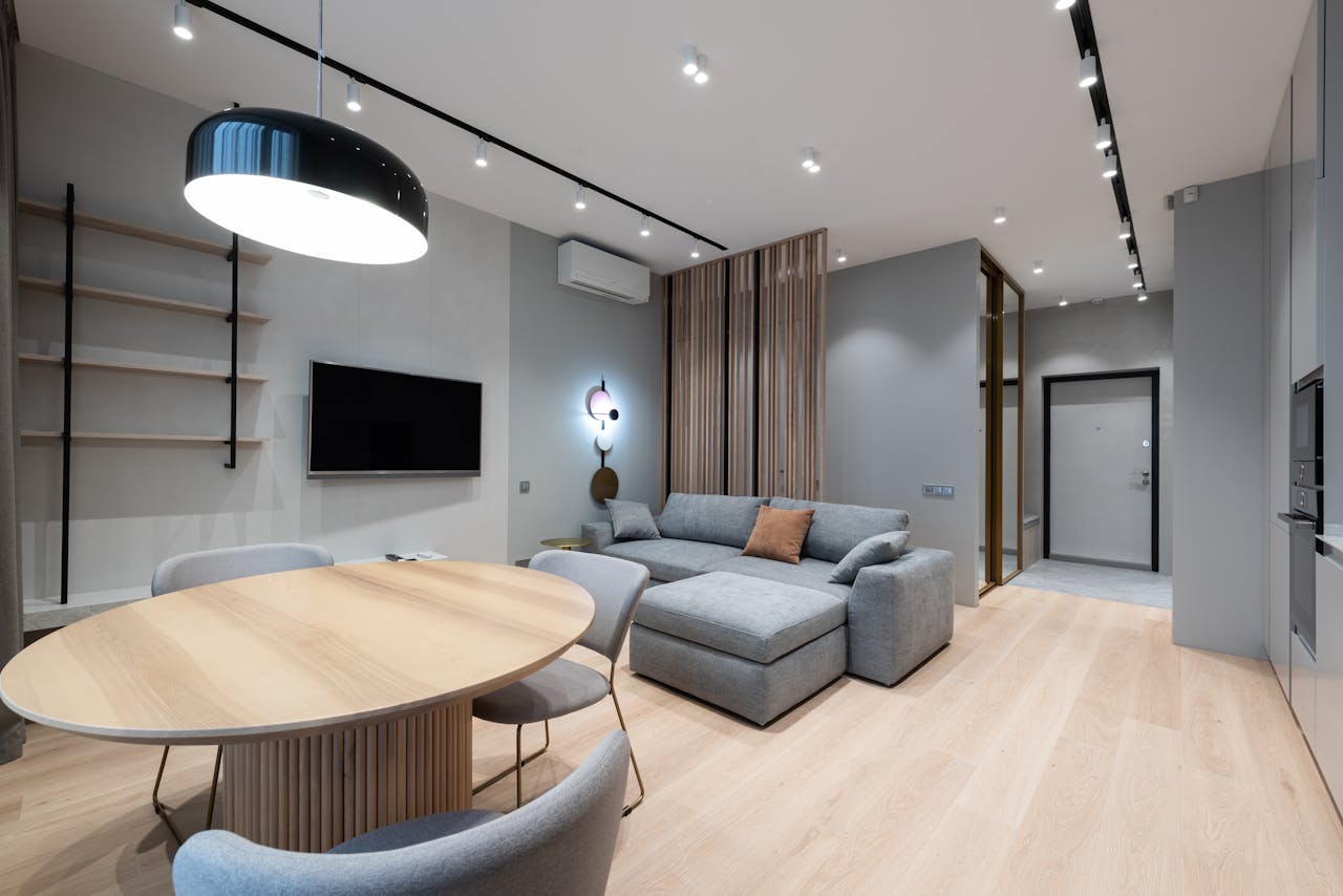 services-01 Design of comfortable studio apartment with grey walls placed near wooden table and chairs
