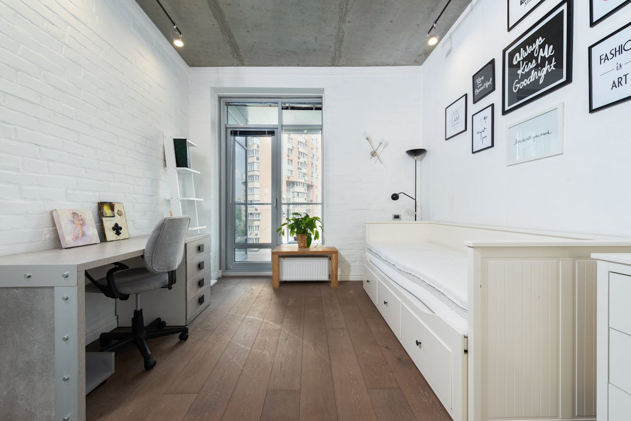 services-03 Bright, minimalist bedroom with contemporary decor and stylish furnishings.