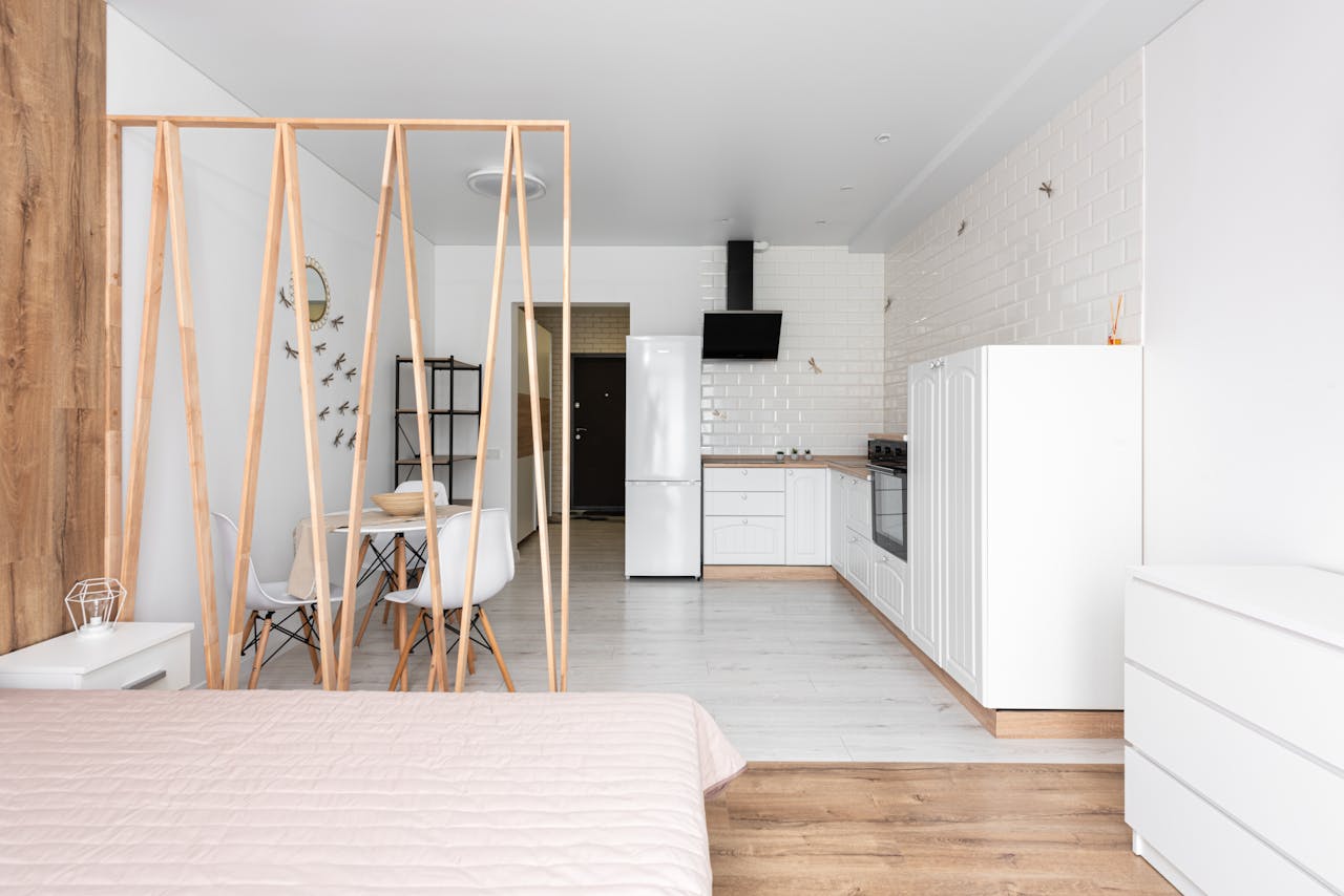 gallery-6 Spacious modern studio apartment featuring an open kitchen and minimalist decor.